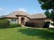 Charming single-story brick home featuring a landscaped front yard and attached two-car garage at 243 Nortwick Rd, Rolesville, NC 27571