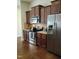 Well-equipped kitchen with stainless steel appliances, rich wood cabinets and granite countertops at 243 Nortwick Rd, Rolesville, NC 27571