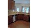 Kitchen features wood floors, granite counters and stainless steel dishwasher and sink at 243 Nortwick Rd, Rolesville, NC 27571