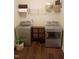 Functional laundry room featuring new washer and dryer with overhead storage at 243 Nortwick Rd, Rolesville, NC 27571