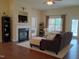 Cozy living room featuring a fireplace, hardwood floors, and access to an outdoor patio at 243 Nortwick Rd, Rolesville, NC 27571
