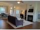 Spacious living room with hardwood floors, a fireplace, and a view of the adjacent dining area at 243 Nortwick Rd, Rolesville, NC 27571
