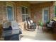 Relaxing covered patio featuring an outdoor grill and comfortable seating at 243 Nortwick Rd, Rolesville, NC 27571