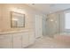 Bright bathroom featuring double vanity, glass shower, soaking tub, and tile floors at 2737 Willow Rock Ln, Apex, NC 27523