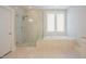 Elegant bathroom with walk-in shower, soaking tub, and neutral tile at 2737 Willow Rock Ln, Apex, NC 27523