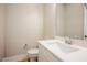 Bright bathroom with modern white vanity, chrome fixtures, and wood-look flooring at 2737 Willow Rock Ln, Apex, NC 27523