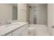 Updated bathroom with granite countertops, white cabinets, and gray tiled shower and walls at 2737 Willow Rock Ln, Apex, NC 27523