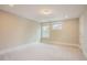 A cozy bedroom is brightened by two windows, white trim, and neutral carpeting at 2737 Willow Rock Ln, Apex, NC 27523