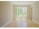 Bright, empty bedroom with hardwood floors and large windows with natural light at 2737 Willow Rock Ln, Apex, NC 27523