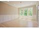 Sun-filled dining room with wainscoting, chandelier, and sliding door to porch for outdoor dining at 2737 Willow Rock Ln, Apex, NC 27523