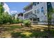 Rear exterior of two-story home with screened porch, stairs, and fenced yard at 2737 Willow Rock Ln, Apex, NC 27523