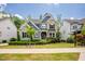 Beautiful two-story home with stone and blue siding and a professionally landscaped front yard at 2737 Willow Rock Ln, Apex, NC 27523
