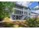 Charming two-story home with a screened porch, stairs, and lush green lawn at 2737 Willow Rock Ln, Apex, NC 27523