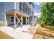 Rear exterior view showing a screened porch, patio, and gray stairs leading to the backyard at 2737 Willow Rock Ln, Apex, NC 27523
