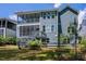 Rear exterior of two-story home with screened porch and staircase with lush green lawn at 2737 Willow Rock Ln, Apex, NC 27523