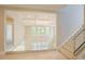 Elegant entryway with tray ceilings, glass railing, and view of open living space at 2737 Willow Rock Ln, Apex, NC 27523