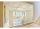 Elegant entryway with coffered ceilings, glass railing, and view of open living space at 2737 Willow Rock Ln, Apex, NC 27523