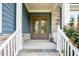 Close-up of a home's double front doors, complemented by stone accents and manicured shrubs at 2737 Willow Rock Ln, Apex, NC 27523