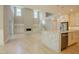 Bright and airy kitchen with white cabinetry, stone countertops, hardwood floors, and modern lighting at 2737 Willow Rock Ln, Apex, NC 27523