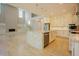 Spacious open-concept kitchen and living area with white cabinets, stone countertops, and hardwood floors at 2737 Willow Rock Ln, Apex, NC 27523