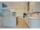 Modern kitchen with white cabinets, stainless steel appliances, and a large island with a stone countertop at 2737 Willow Rock Ln, Apex, NC 27523