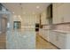 Contemporary kitchen featuring white cabinets, stone countertops, and stainless steel appliances at 2737 Willow Rock Ln, Apex, NC 27523