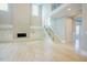 Spacious living room featuring a staircase, fireplace, built-in storage, and lots of natural light at 2737 Willow Rock Ln, Apex, NC 27523