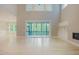 Bright living room boasts large windows, light hardwood floors and seamless access to outdoor living at 2737 Willow Rock Ln, Apex, NC 27523