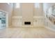 Spacious living room featuring a staircase, fireplace, built-in storage, and lots of natural light at 2737 Willow Rock Ln, Apex, NC 27523
