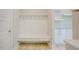 Mudroom features a built-in bench with hooks and convenient access to shelving for storage at 2737 Willow Rock Ln, Apex, NC 27523