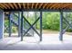 Spacious concrete patio supported by gray beams, providing access to a lush backyard with ample space at 2737 Willow Rock Ln, Apex, NC 27523