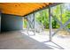 Covered patio is brightened with natural light and access to backyard area and stairs at 2737 Willow Rock Ln, Apex, NC 27523