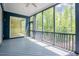 Screened-in porch offers an extension of living space with views of surrounding trees at 2737 Willow Rock Ln, Apex, NC 27523
