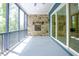 Covered porch with stone fireplace and ceiling fan, great for relaxing or entertaining outdoors at 2737 Willow Rock Ln, Apex, NC 27523