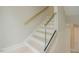 Modern staircase with glass railing and wood treads, providing a sleek design at 2737 Willow Rock Ln, Apex, NC 27523