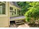 View of a backyard deck with stairs, exterior home siding, and green foliage in the yard at 2819 Ellis Chapel Rd, Bahama, NC 27503