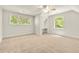 Bright bedroom featuring neutral carpet, a ceiling fan, and two windows offering a calming view of the outdoors at 2819 Ellis Chapel Rd, Bahama, NC 27503