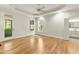 This bedroom features tray ceilings, a ceiling fan, hardwood floors, and access to an outdoor deck or patio at 2819 Ellis Chapel Rd, Bahama, NC 27503