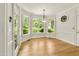 Bright dining area featuring hardwood floors, wainscoting, large windows, and access to outdoor patio or deck at 2819 Ellis Chapel Rd, Bahama, NC 27503