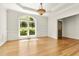 This dining room boasts hardwood floors, large windows offering natural light, and elegant chandelier at 2819 Ellis Chapel Rd, Bahama, NC 27503