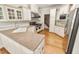 Well-appointed kitchen featuring white cabinets, granite countertops, stainless steel appliances and hardwood flooring at 2819 Ellis Chapel Rd, Bahama, NC 27503