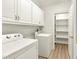 Convenient laundry room with white cabinetry, appliances, and access to a shelved pantry at 2819 Ellis Chapel Rd, Bahama, NC 27503