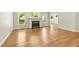 Bright living room with a fireplace, hardwood floors, and large windows providing natural light and outdoor views at 2819 Ellis Chapel Rd, Bahama, NC 27503