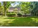 This lovely home features beautiful landscaping, mature trees, and views of the surrounding greenery in the backyard at 2819 Ellis Chapel Rd, Bahama, NC 27503