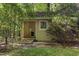 Quaint garden shed surrounded by trees, greenery and a small ramp-style entrance at 2819 Ellis Chapel Rd, Bahama, NC 27503