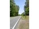 A peaceful street view with a mailbox marked '2819' surrounded by lush greenery on a sunny day at 2819 Ellis Chapel Rd, Bahama, NC 27503