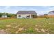 Backyard with a lawn, privacy fence, and patio area, with chairs and umbrella at 297 Sexton Ln, Wendell, NC 27591