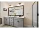 Double vanity bathroom with gray cabinetry, quartz countertops, and a large mirror at 297 Sexton Ln, Wendell, NC 27591