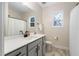 Clean bathroom features a vanity with countertop, a large mirror, and modern fixtures at 297 Sexton Ln, Wendell, NC 27591