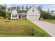 Beautiful single-Gathering home with lush green lawn, welcoming front porch with American flag, and attached two-car garage at 297 Sexton Ln, Wendell, NC 27591